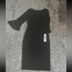 This is a brand new Calvin Klein midi dress in black